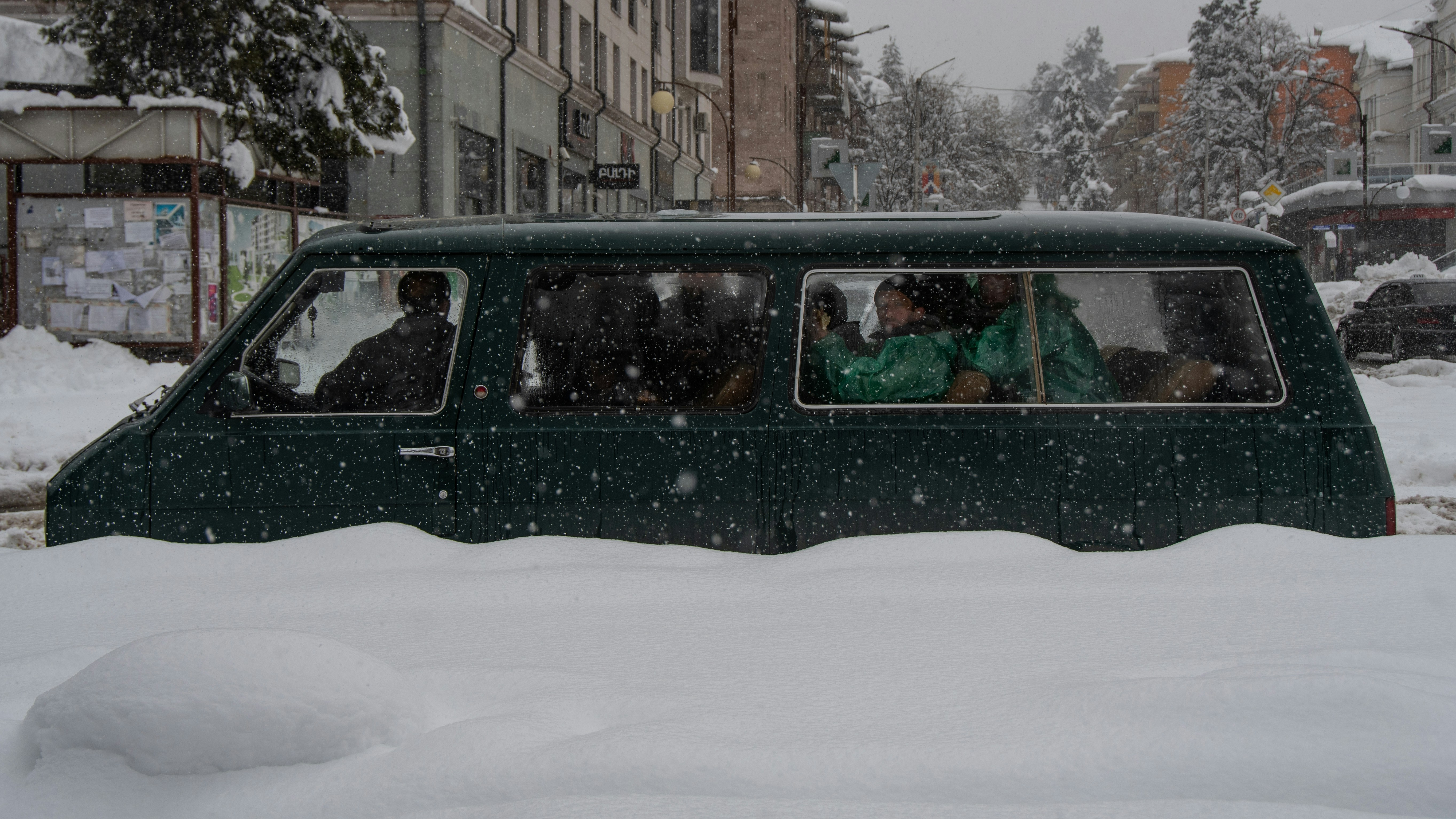 People in car in snow in Karabakh